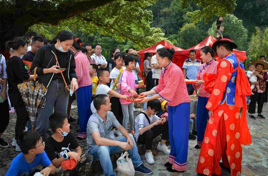 福建土楼永定景区里，游客踊跃参与体验民俗演艺活动 温学元 摄