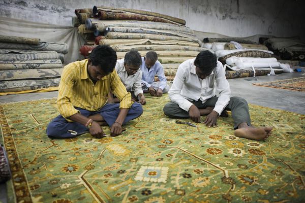  资料图：印度北方邦城市珀多希的一家手工地毯工厂里的工人们正在加工即将完成的地毯。新华社记者郑焕松摄