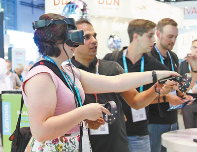 参观者在联想集团展台前体验虚拟现实（VR）设备。 　　本报记者 李 强摄