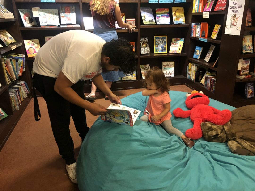 一位顾客在陪小孩阅读。