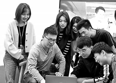     杨勇（左二）带领腾讯安全平台部技术团队进行AI安全技术研讨。资料图片
