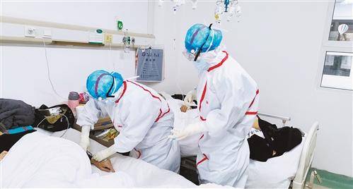  △资料图：奋战在武汉金银潭医院的国家中医医疗队大夫们正在为患者诊治。