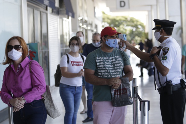 ▲巴西首都巴西利亚，顾客在商场外接受体温检测