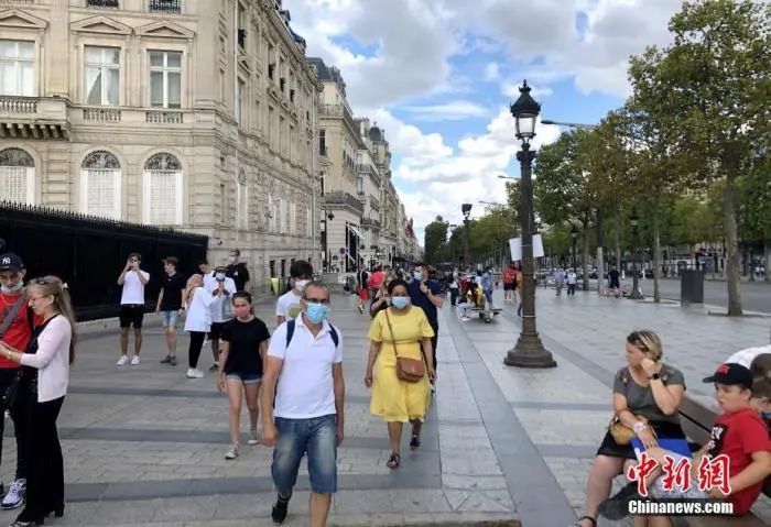 当地时间8月14日，巴黎被法国官方列为新冠病毒传播“高风险地区”。图为当天在巴黎香榭丽舍大街的民众，其中一些人仍未戴口罩。中新社记者 李洋 摄