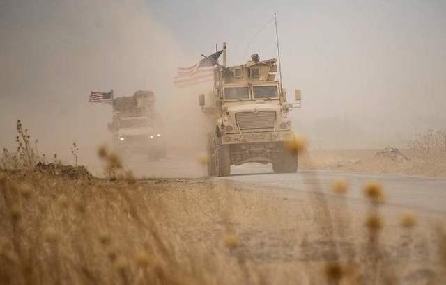 在叙利亚一处油田附近行驶的美军装甲车 图源：视觉中国