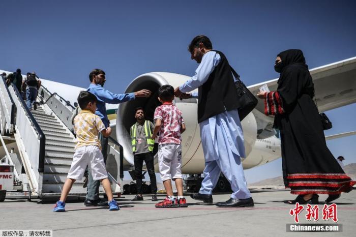 资料图：当地时间9月13日，阿富汗喀布尔机场，乘客登上巴基斯坦国际航空公司的航班。据报道，这是自阿富汗塔利班8月15日重新接管喀布尔以来，首个降落的国际商业航班。
