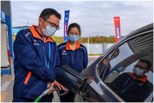 图为“浙江石油”综合供能服务站员工将高质量的油品和热情的服务注入车主心田