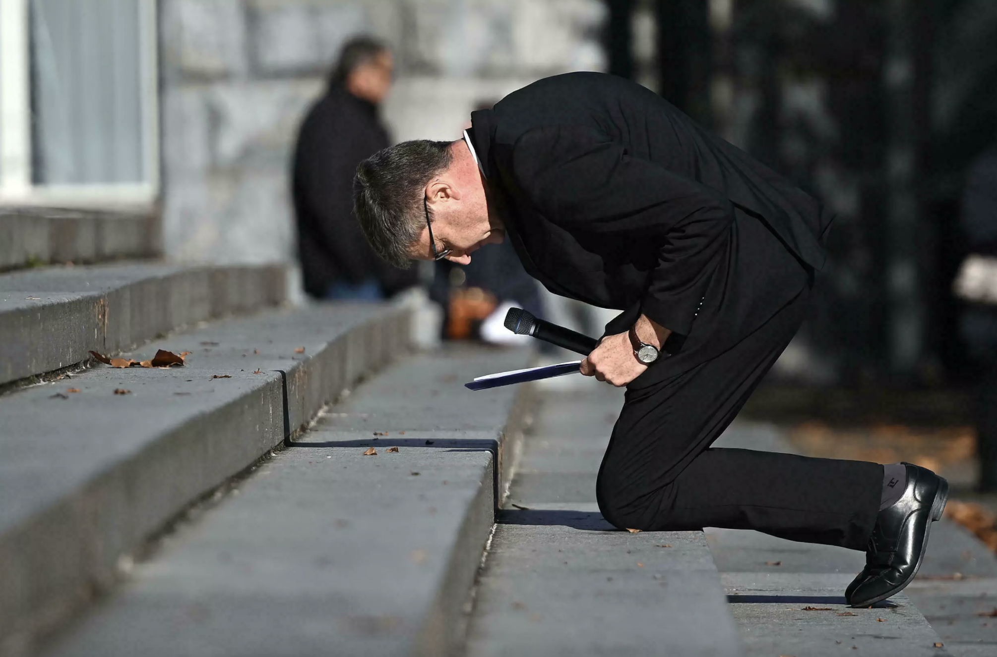 法国天主教会的高级神职人员跪下祈祷以示忏悔。（图源：法新社）