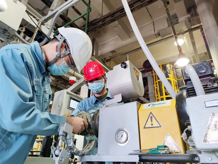 仪征化纤技术人员在生产线上进行设备调试