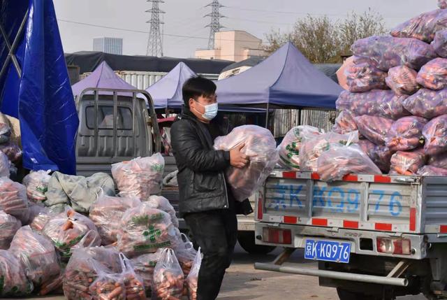 进入11月中旬，北京蔬菜供应偏紧局面正在缓解。图为商户在搬运胡萝卜。新京报记者 陈琳 摄