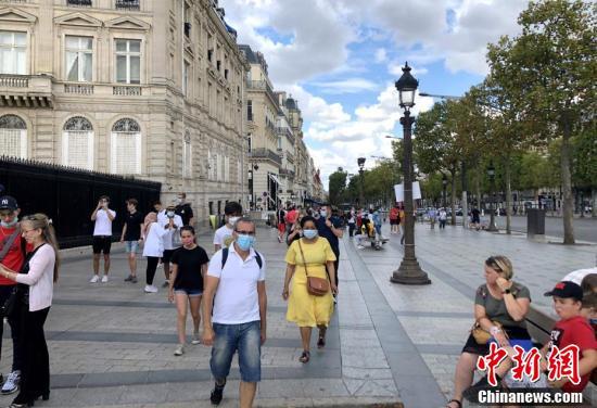 当天在巴黎香榭丽舍大街的民众，其中一些人仍未戴口罩。（中新社记者 李洋 摄）