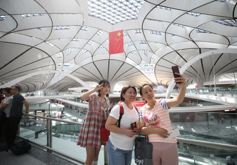 北京大兴机场旅客自拍留念。（中国日报记者 陈泽冰 摄）