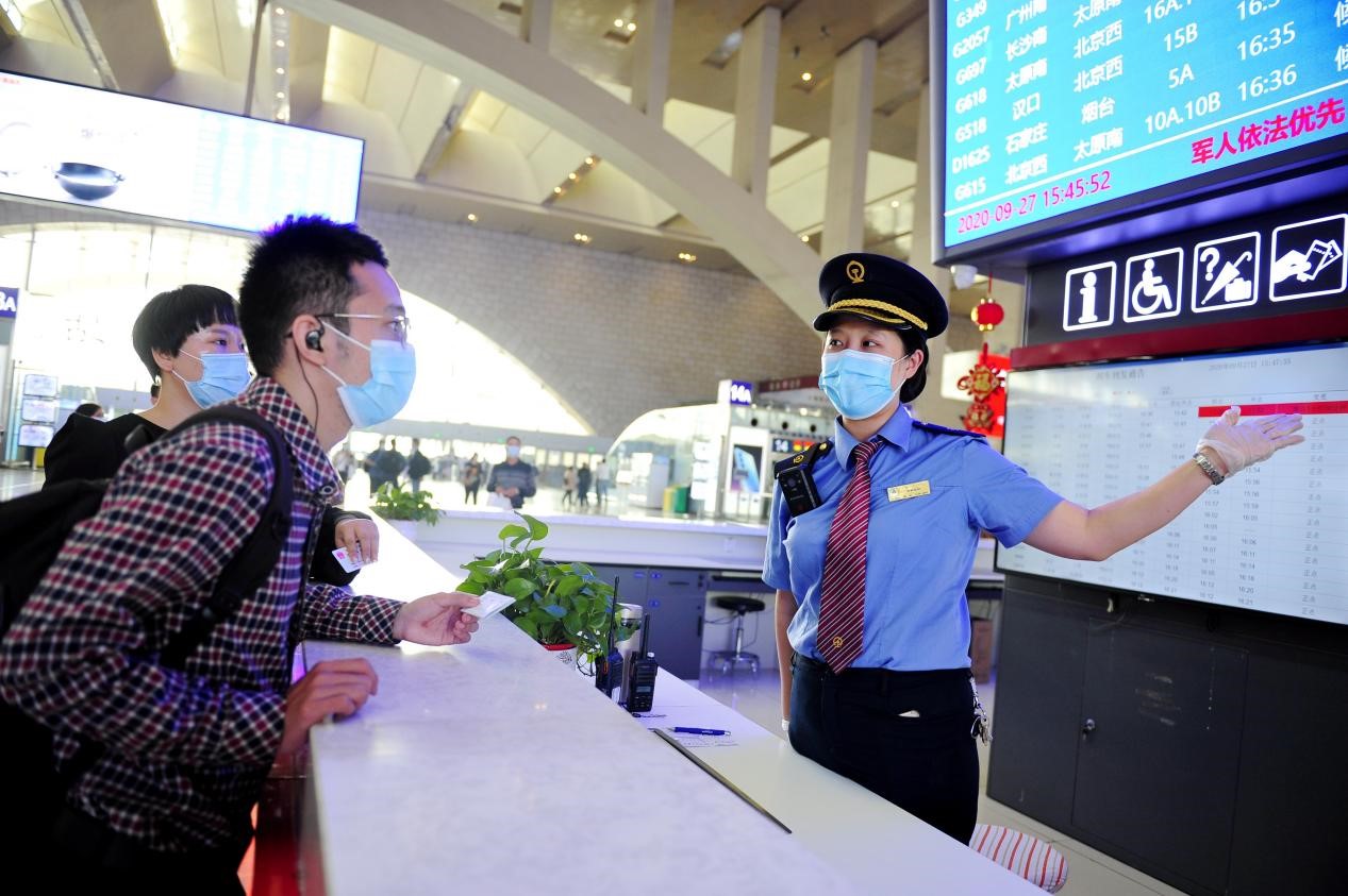 石家庄火车站客运员正在为旅客解答难题.受访者供图