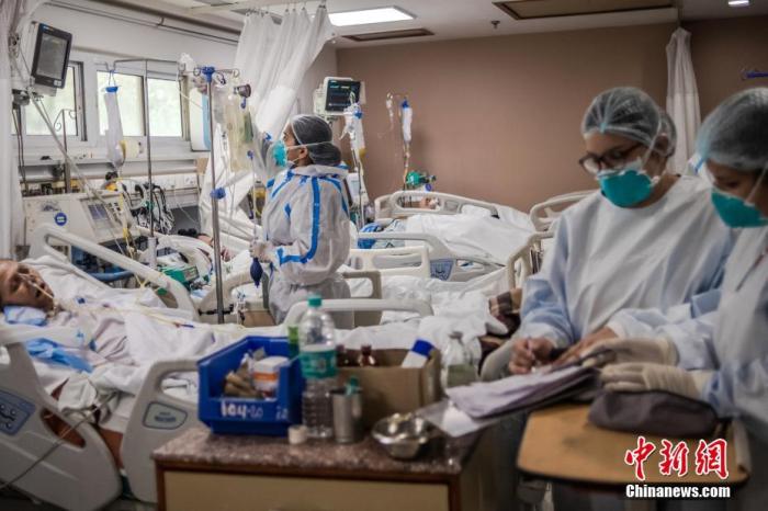 当地时间2021年5月6日，印度新德里，医务人员在圣家医院的ICU病房照料新冠肺炎患者。 图片来源：视觉中国