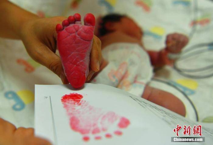 资料图:"身份证"上印上宝宝的小脚丫.中新社记者 翟羽佳 摄