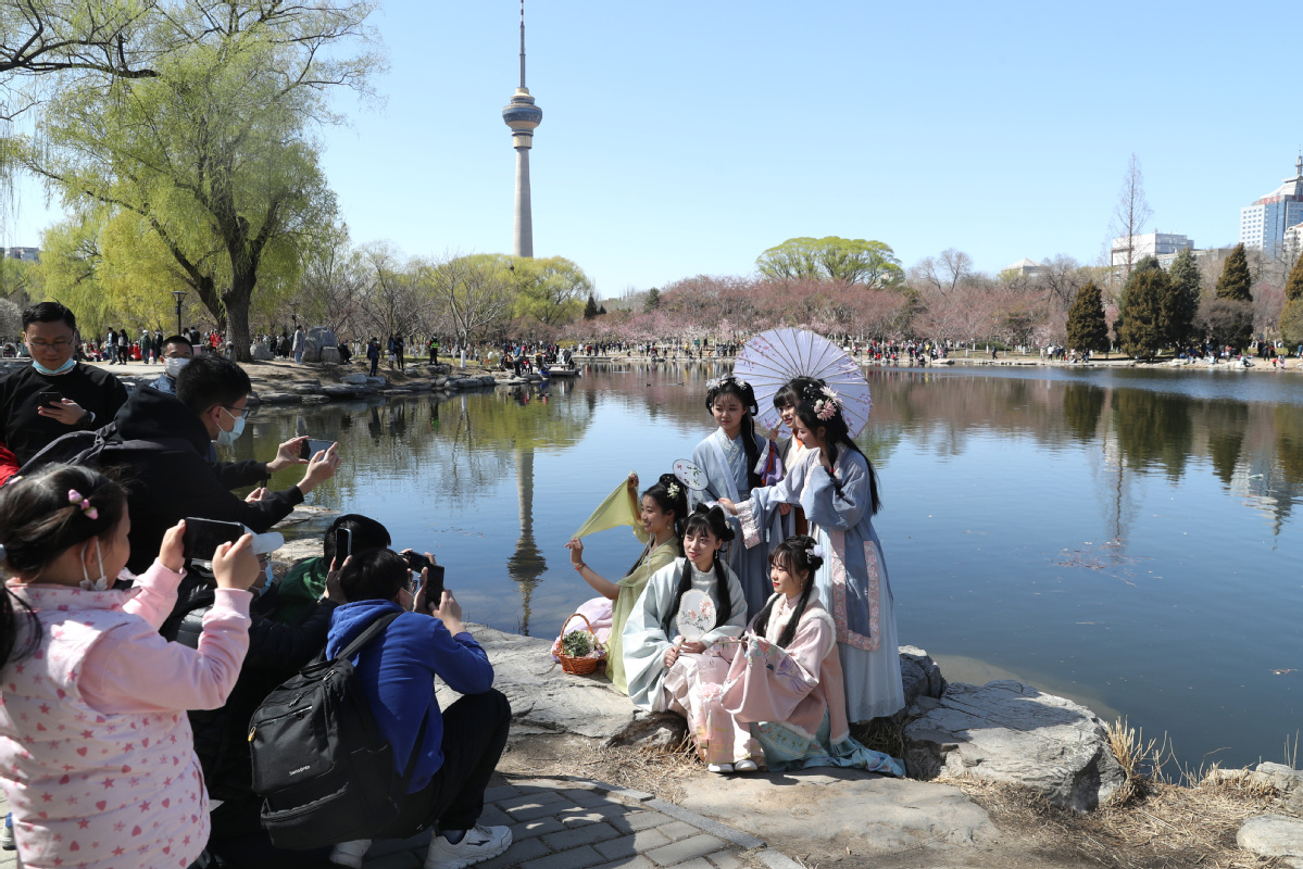 3月27日，身着汉服的姑娘们在八一湖畔拍照留念。中国日报记者 邹红 摄