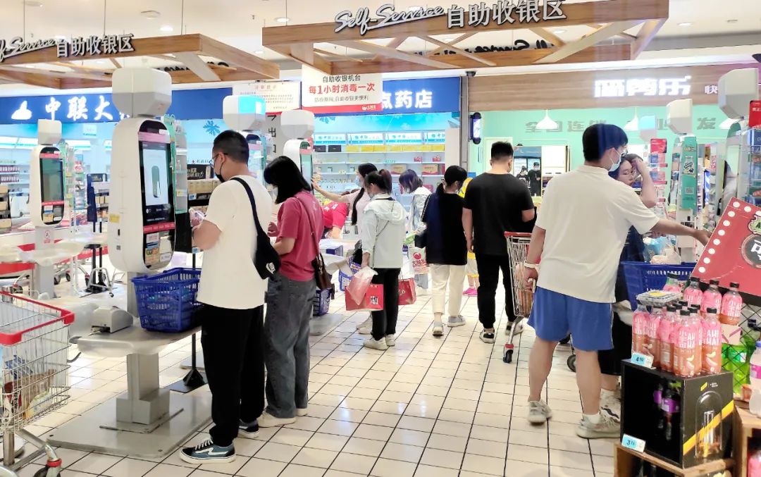 在商超收银区域,满载而归的顾客有序付款.钟政宽 摄