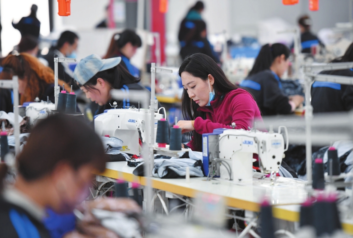工人在延安市延川县华延服装公司车间内工作(3月31日摄).