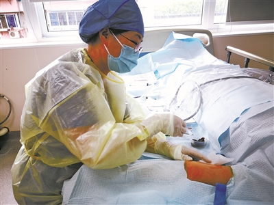 李惠利医院专科护士茹晚霞在门诊室给患者进行picc穿刺.