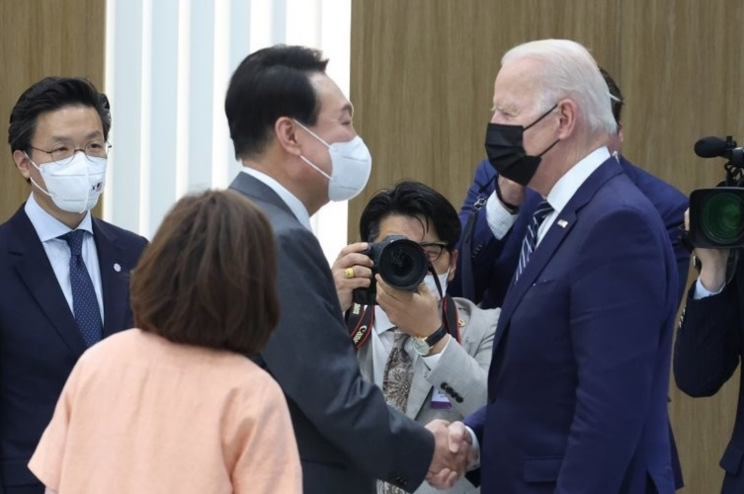 5月20日，在位于京畿道平泽市的三星电子半导体工厂，韩国总统尹锡悦（左）和美国总统拜登在视察工厂之前握手致意。拜登当天下午抵韩，开始对韩国进行为期三天的正式访问。图：韩联社
