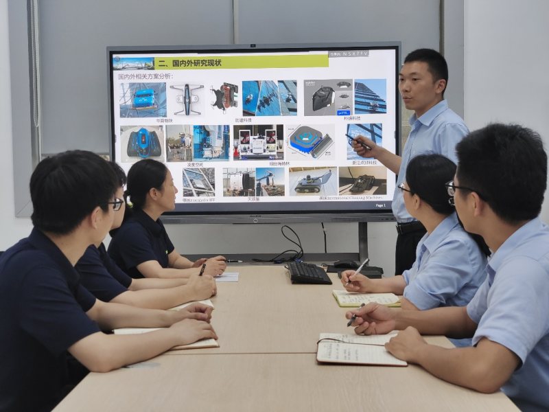 王汉松(右三)在和团队讨论方案.受访者供图