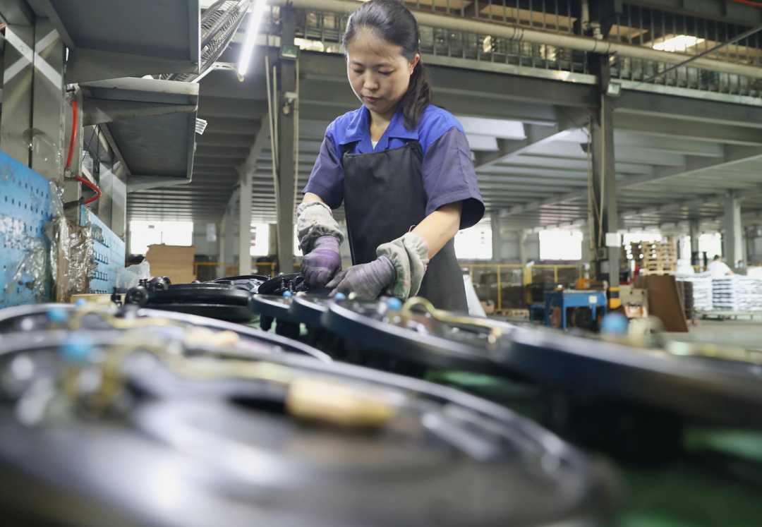 7月5日,员工在河间市一家汽车配件厂用叉车运送货物.