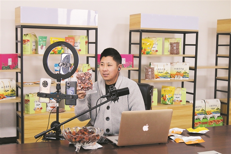 新疆垦爱农业科技有限公司员工通过网络直播销售杏产品（资料图片）。姚吕 慕进军 摄