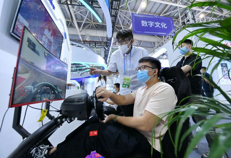 ↑7月22日，观众在第五届数字中国建设成果展览会上体验模拟赛车。新华社记者 林善传 摄