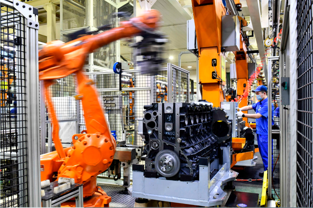 7月24日,山东潍坊的潍柴集团总装车间,机器人在流水线上装配发动. .