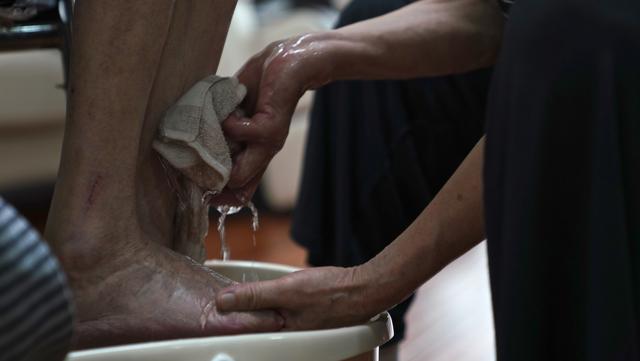 8月2日,许再霞在家中帮丈夫洗脚.新华社记者 胡晨欢 摄