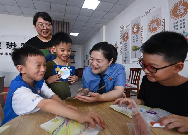 8月11日，湖州市南浔区检察院工作人员为黄泥兜村的孩子和家长做未成年人保护普法宣传。新华社记者 徐昱 摄