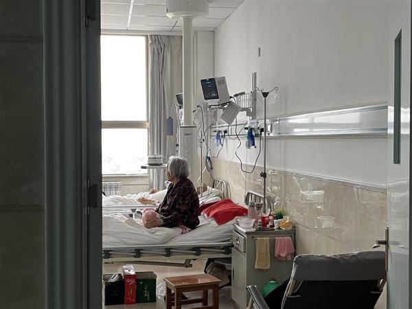 1月14日,甘肃庆阳市某医院,一位老人坐在呼吸科病房的床上. 王倩 摄