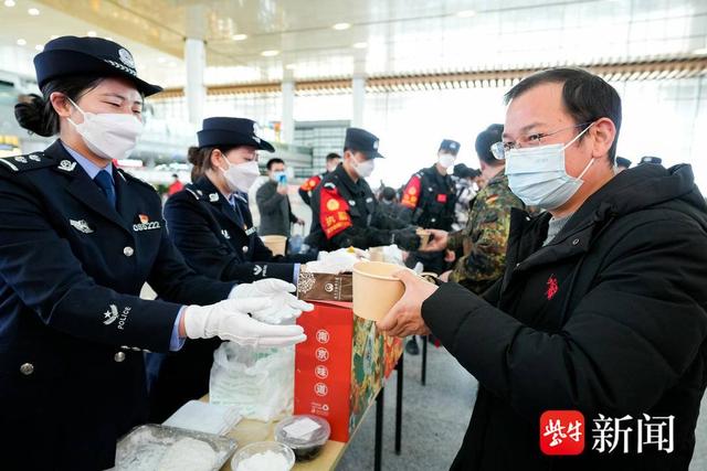 图为南京铁警跟旅客同庆元宵