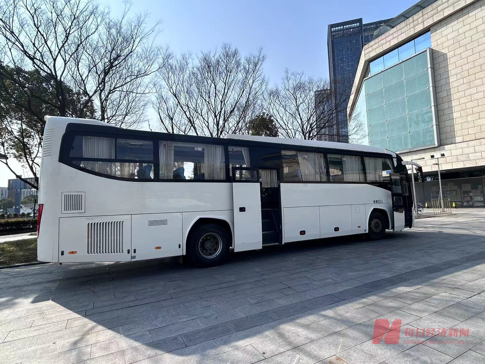 产业园前停靠的接送务工人员的大巴. 图片来源:每经记者 程雅 摄