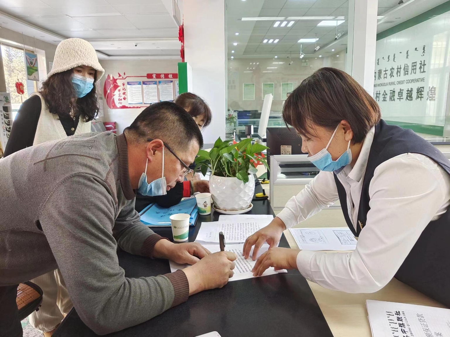 乌拉特中旗联社客户经理为客户办理贷款.辛文/摄