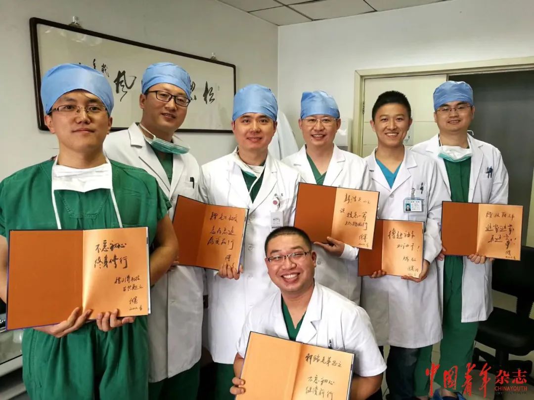 张骞(左三)向进修医生赠送他主编的《泌尿外科腹腔镜手术——操作技术