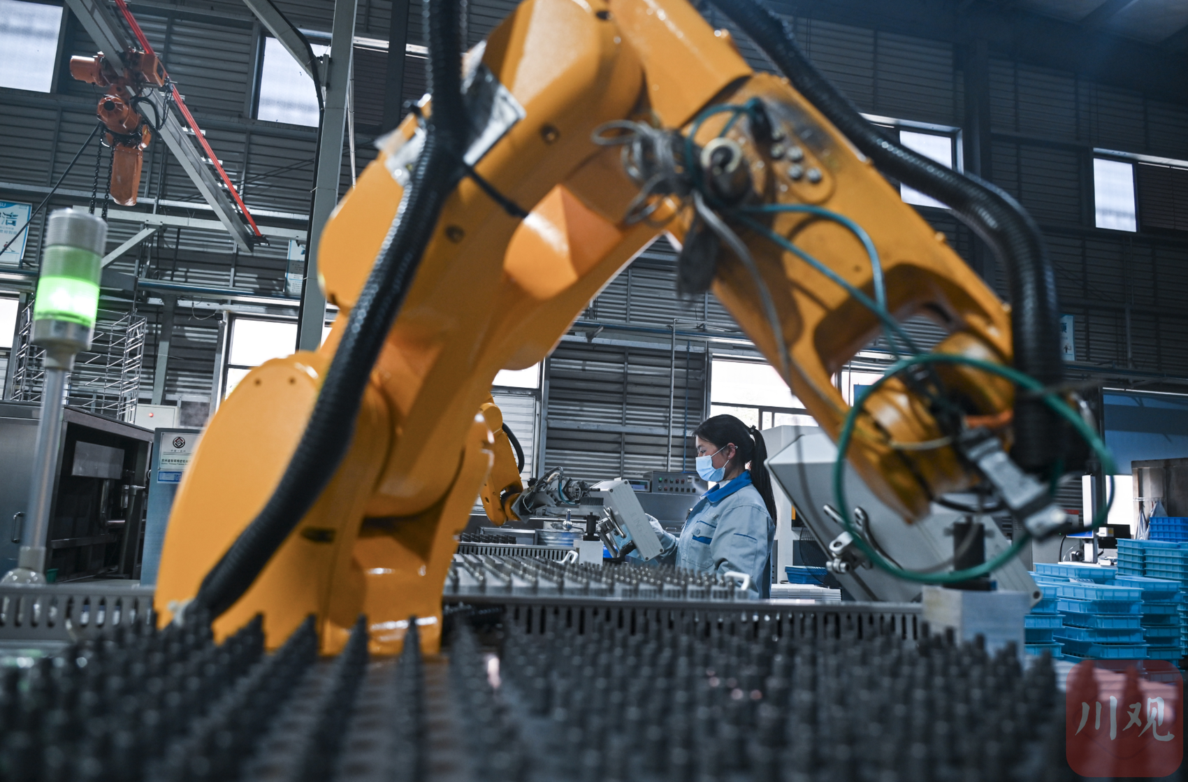 车间忙碌的机器人.工厂的全自动生产线正在生产,工人却寥寥无几.