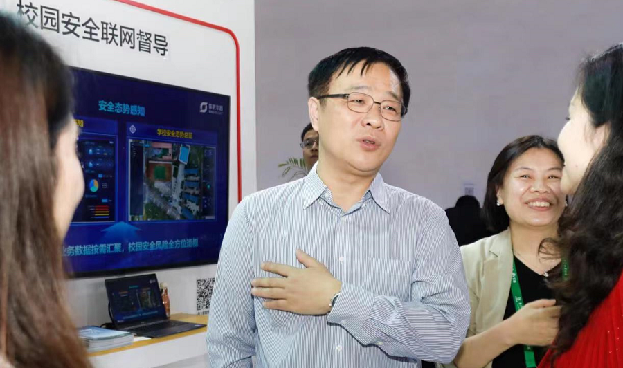中国教育装备行业协会副会长夏国明（中）参观新华三展区
