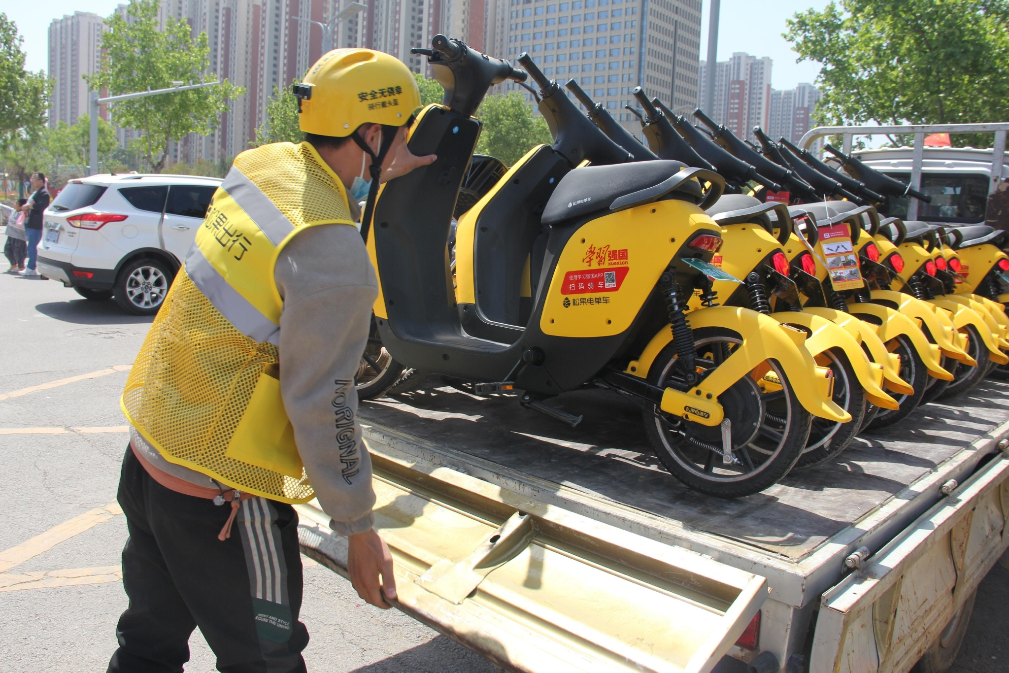 强国电单车运营人员在用车高峰时段加紧调度车辆