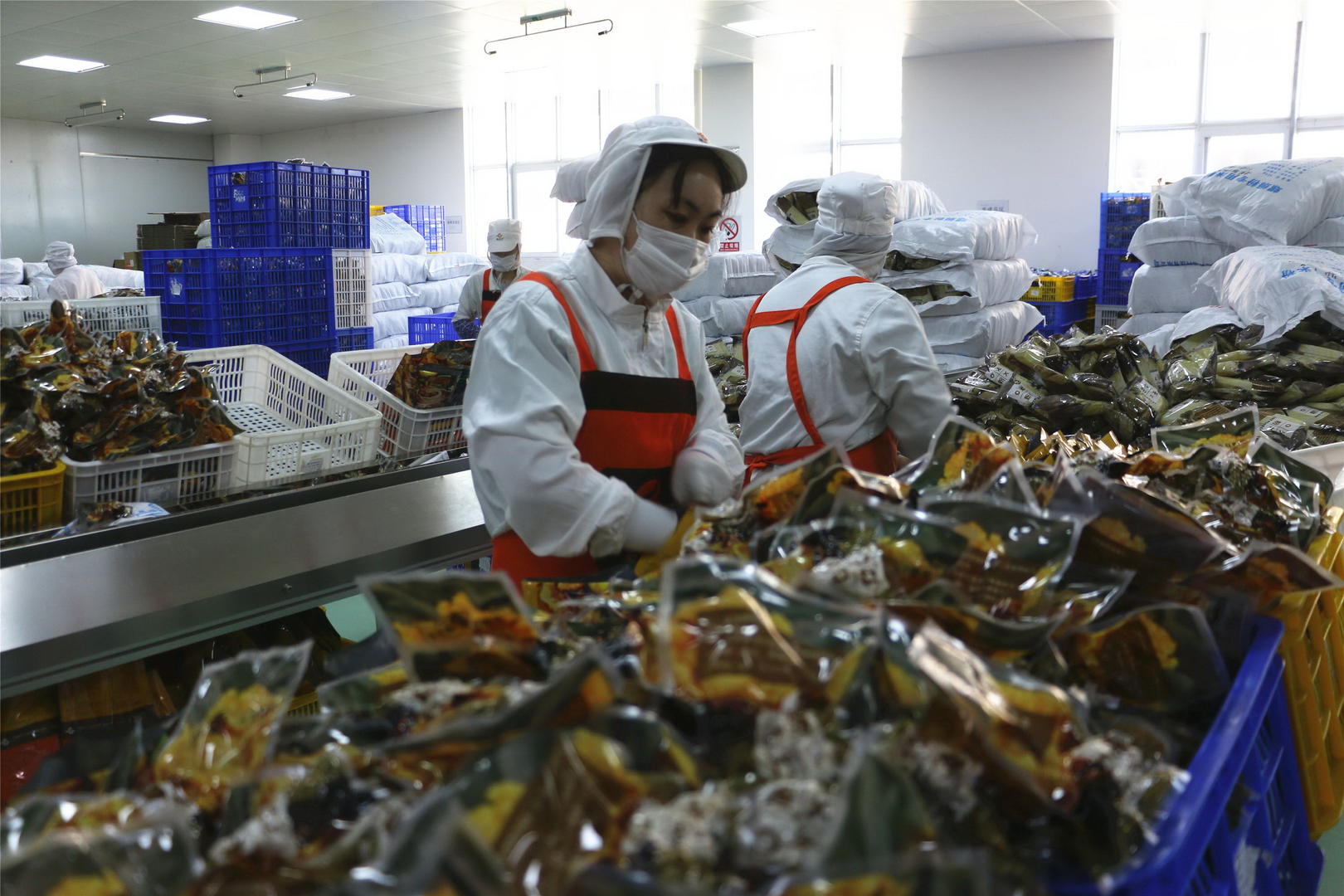 柳州某家螺蛳粉生产企业，工人正忙着包装、运输螺蛳粉。图据IC photo