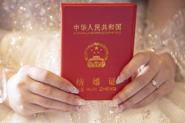 一位新娘手持结婚证.