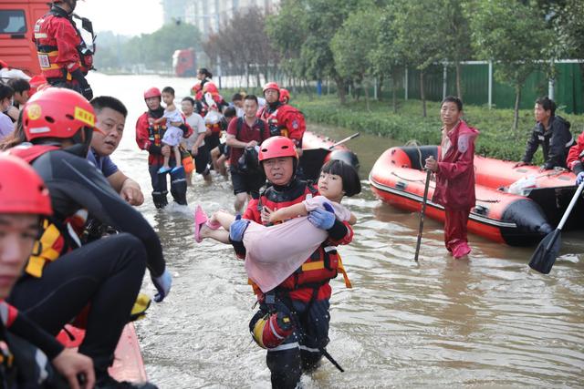 2021年,河南暴雨,陈雄伟正抱着孩子转运.图源:密云区消防救援支队