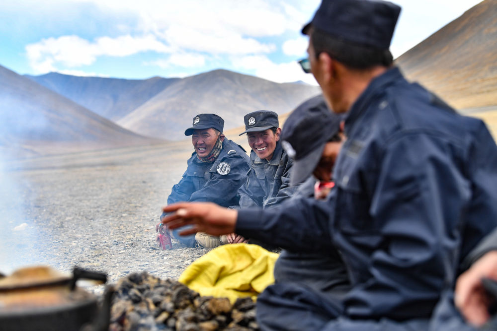 护边联防队队员在一块空地上准备午餐（6月2日摄）。