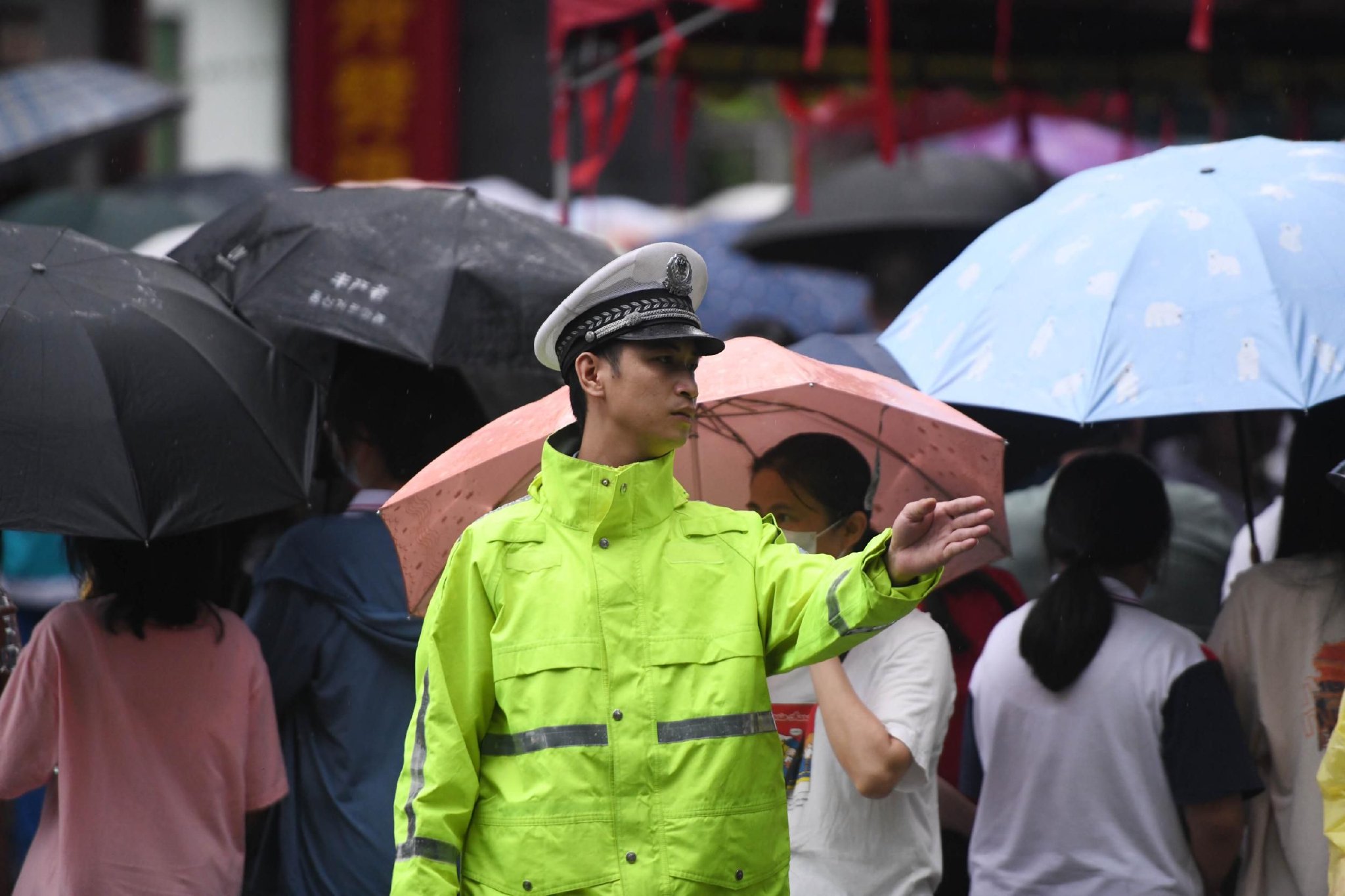 6月7日,海南中学三亚学校考点前,三亚交警雨中执勤,为高考保驾护. .
