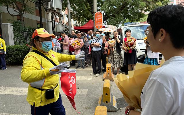 6月10日中午，家长们拿着鲜花迎接考生。新京报记者刘洋 摄