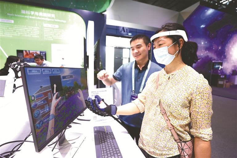 图为观众在2023中关村论坛展览（科博会）上体验脑机接口手功能康复训练与评估系统。图片来源：视觉中国