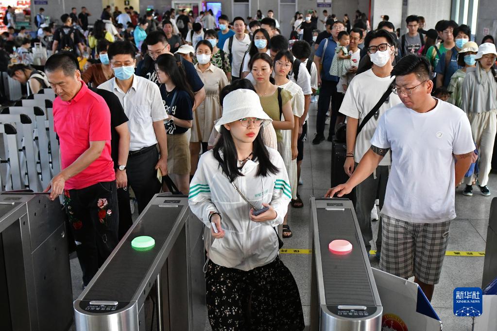 7月1日，旅客在山东烟台南站通过闸机进站乘车。新华社发（孙文潭 摄）
