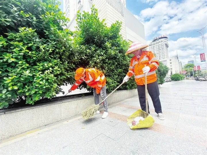 高温下,环卫工人仔细清扫,扮靓城市"容颜".记者 黄红锦 摄