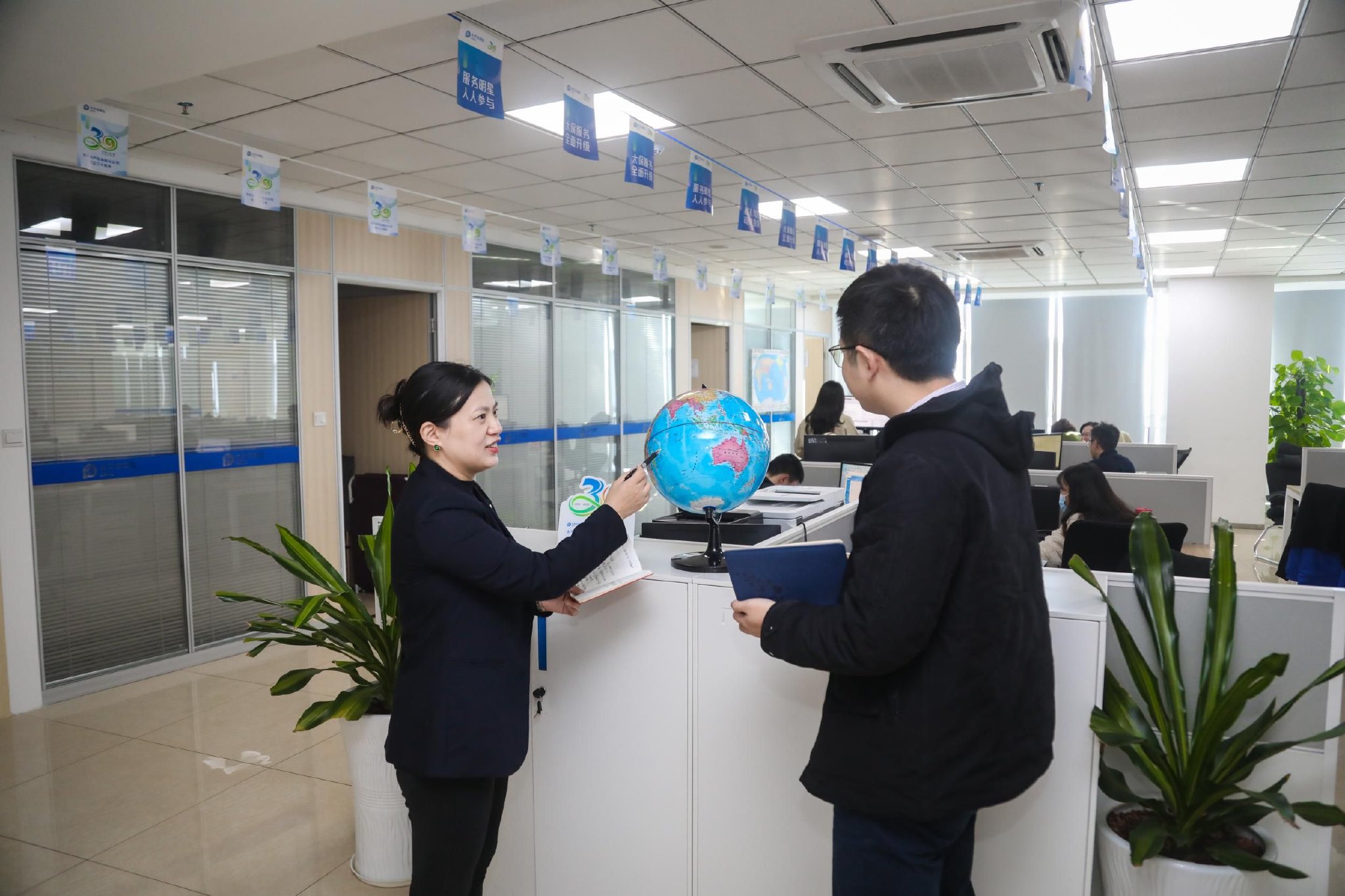 张熙与同事交流.记者 姚皓 摄