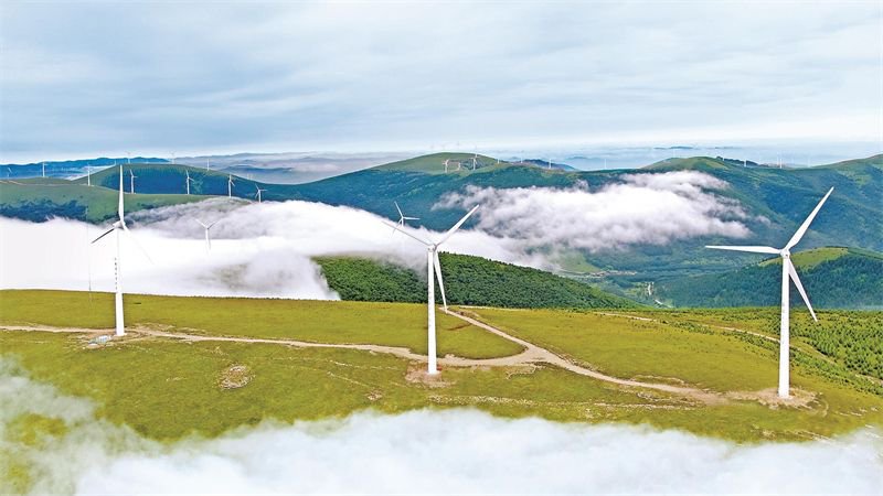 豐寧滿族自治縣大灘鎮的風力發電機組形成的風車群在壩上草原運轉.